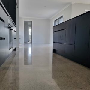 polished concrete floor in kitchen with grey cabinets