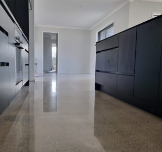 polished concrete floor in kitchen with grey cabinets