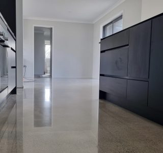 Salt and Pepper beachhouse finish to a kitchen floor with grey black kitchen cabinets on either side