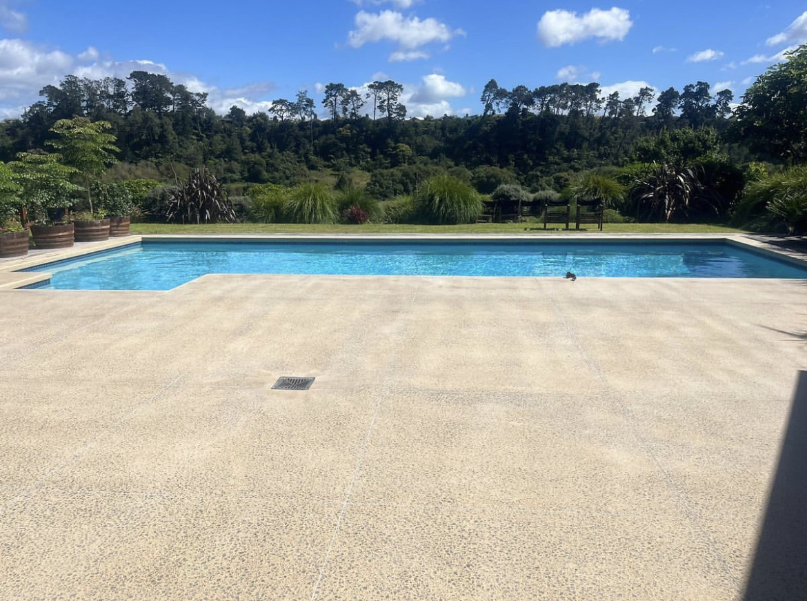 A pool with concrete tiles around that have been ground back and bush hammered to create a non slip area