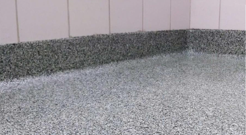 Flake flooring coving edge with grey and white flakes