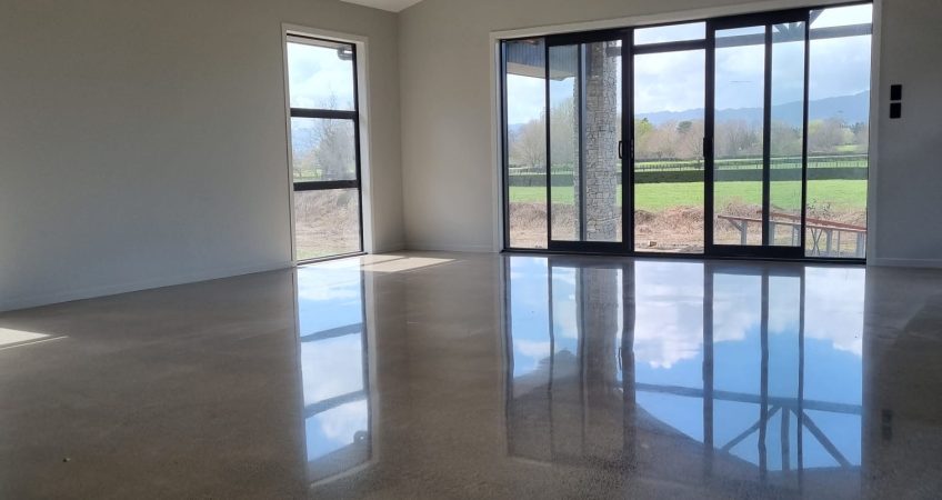 Polished concrete floor in partly built house lounge empty room