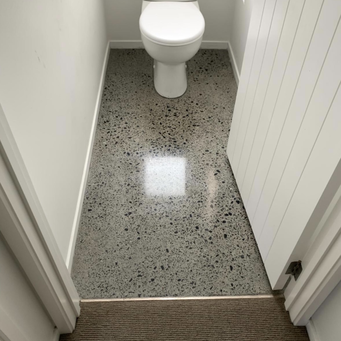 Toilet floor polished concrete grind and seal