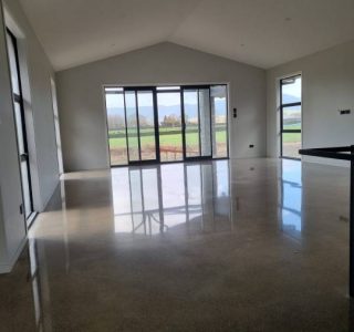 Salt and pepper finish for a beach house polished concrete floor nz grinders tauranga lounge area