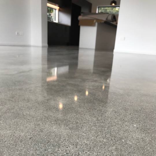Salt and pepper finish for a beach house polished concrete floor nz grinders tauranga hallway