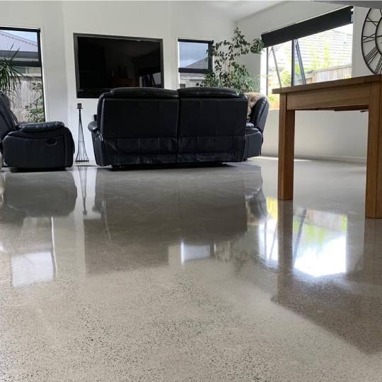 Salt and pepper finish for a beach house polished concrete floor nz grinders tauranga living room